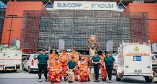 SES staff standing in front of Suncorp stadium