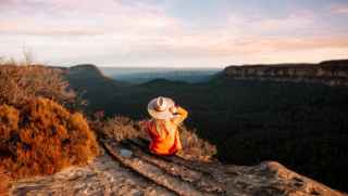 Woman sitting on mountain