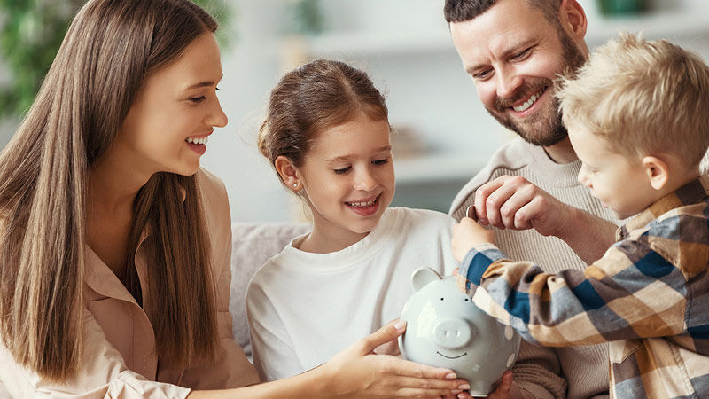 Suncorp Bank Kids Savings Account - family of four saving money in a piggy bank