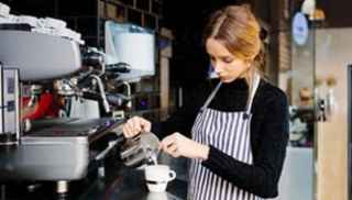 a woman pouring milk into a cup