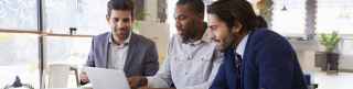 Two men with laptop at coffee shop