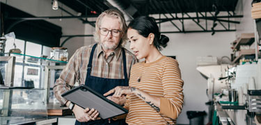 Man and women looking at tablet