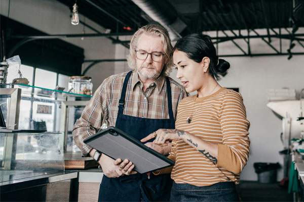 Man and women looking at tablet