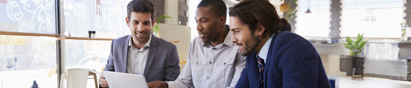 Two men looking at laptop