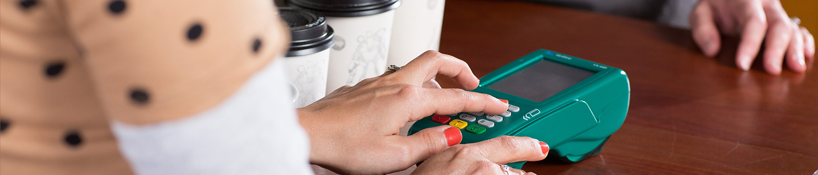 Person pushing buttons on EFTPOS machine