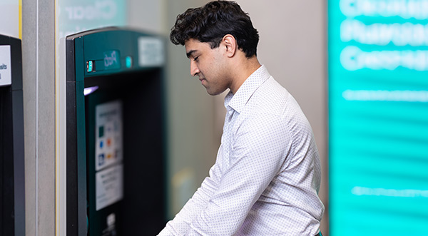 Customer using ATM at Suncorp Bank branch