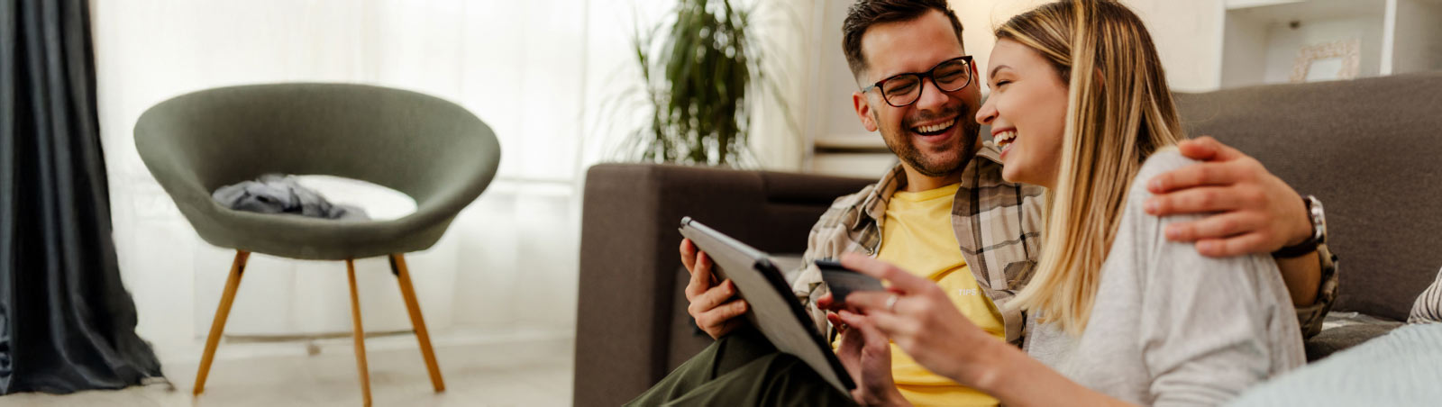Suncorp Bank Accounts – a man and a woman checking their Suncorp Bank account 