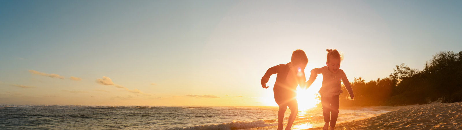 Suncorp Bank Kids Bank Accounts – two kids running on a beach at sunset