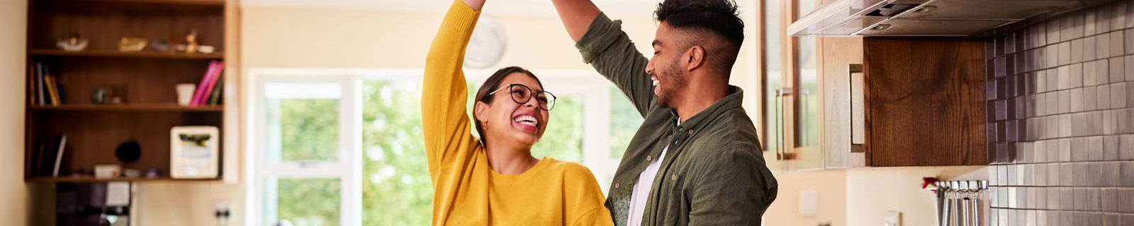 Young couple dancing in the kitchen