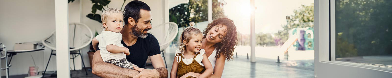 Couple with two young children sitting outside