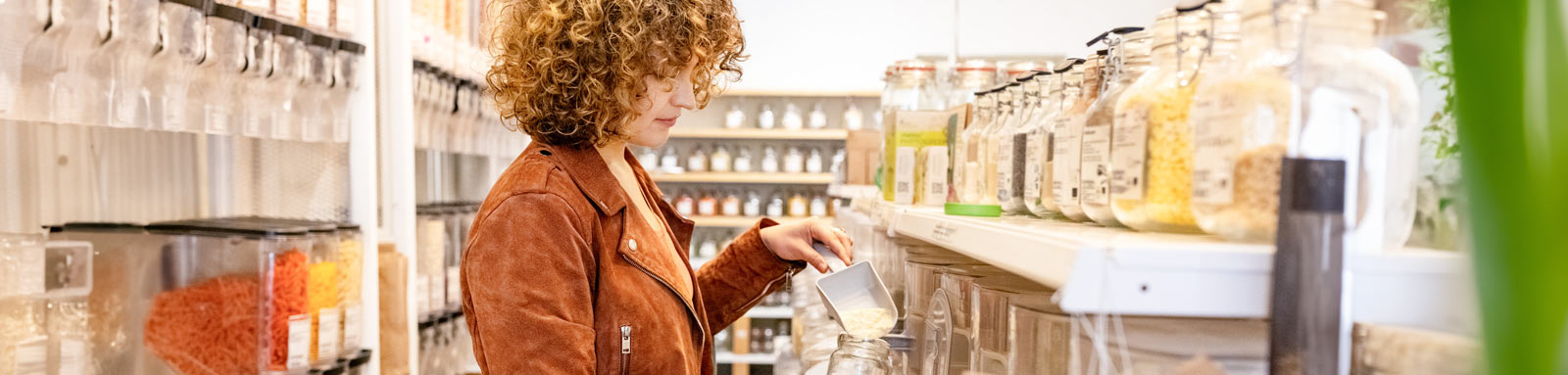 woman-buying-food-at-sustainable-shop-1600x383.jpg