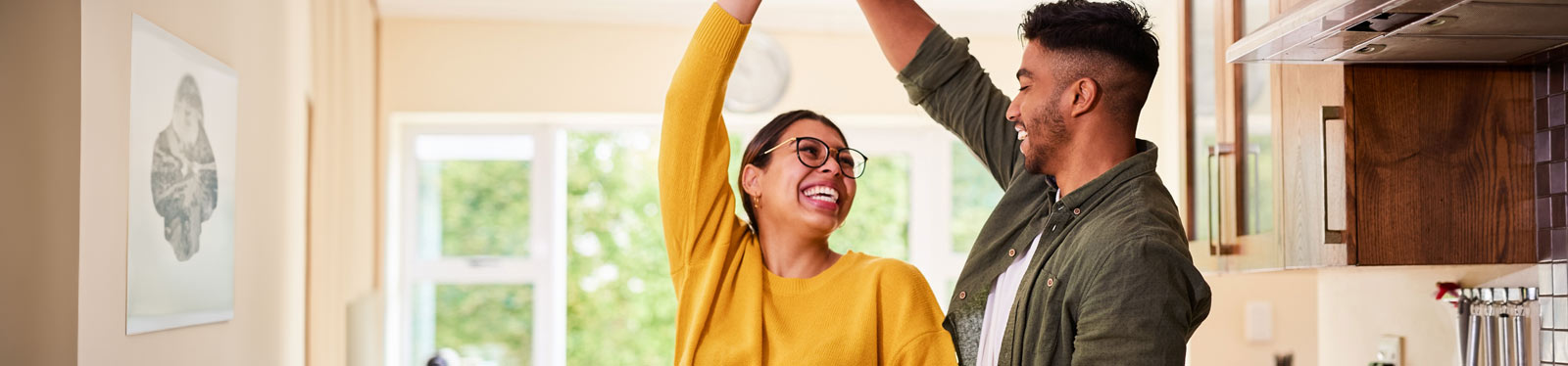 Young couple dancing in the kitchen