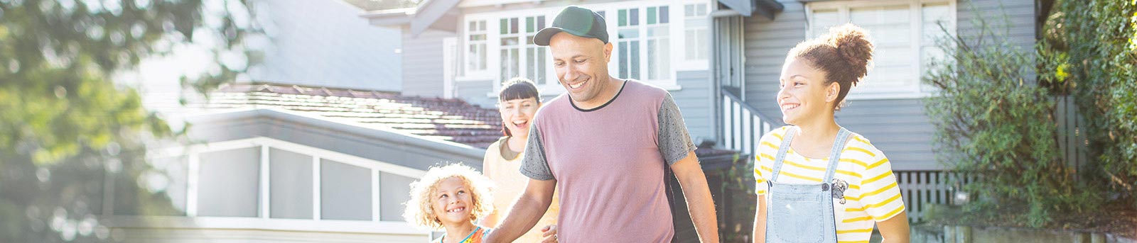 Family walking in front of house