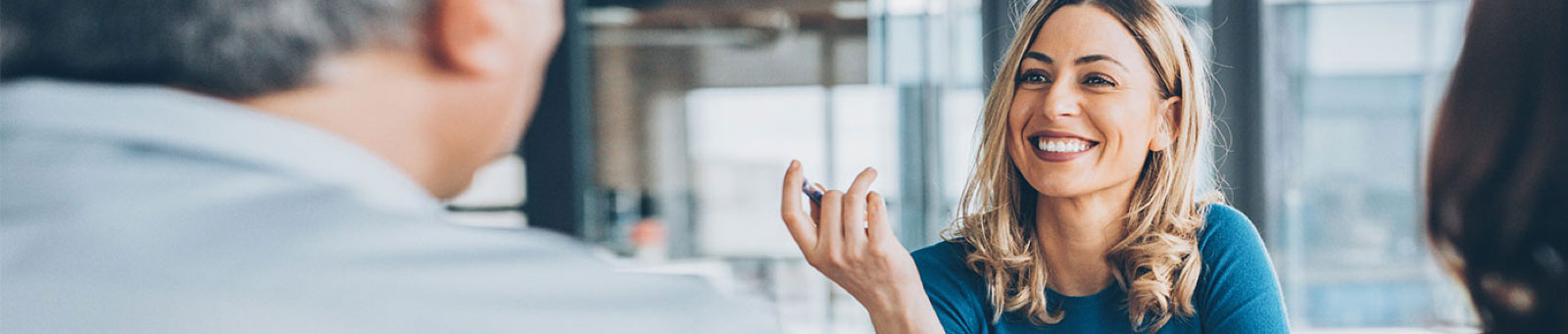 Woman smiling in business meeting