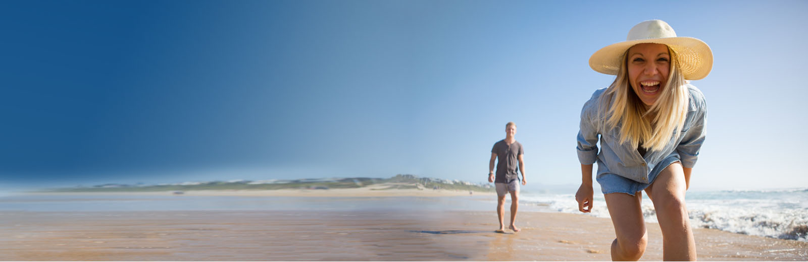 Couple walking on beach and smiling