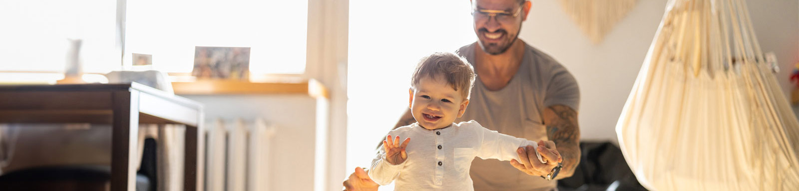 Father and daughter playing on living room floor