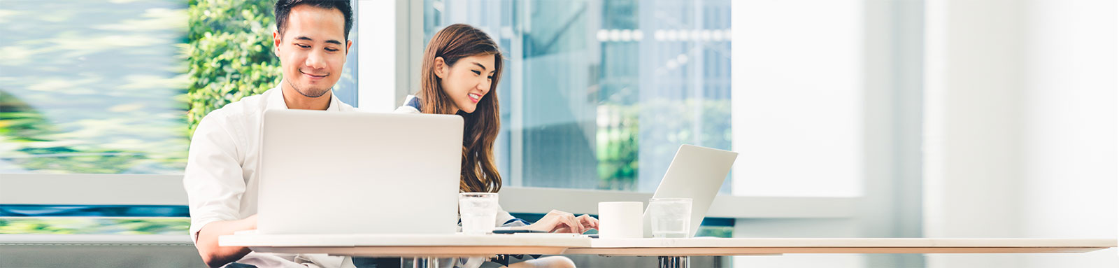 Man and woman working on laptop