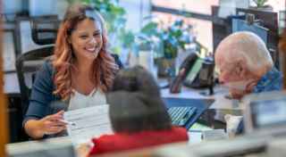 Woman serving two customers