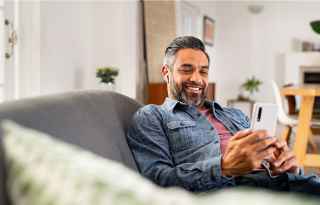 Mans looking at smartphone
