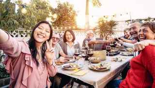 Group of people eating together outdoors